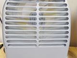 a small air conditioner sitting on a wooden table