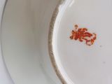 a white plate with a red flower on it
