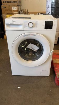 a washing machine that is sitting in the middle of a room