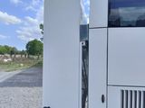 a white bus that is parked on the side of the road