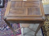 a small wooden table with a drawer on top of it