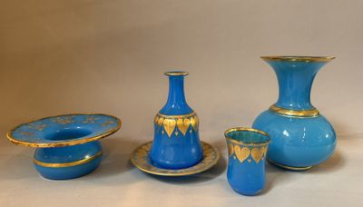 a group of blue and gold vases and bowls on a table