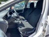 the interior of a car with the door open showing the driver ' s seat