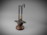 an image of a metal candle holder with a candle inside of it
