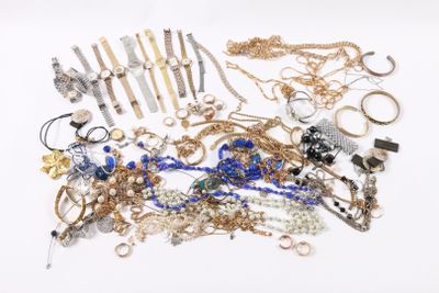 a pile of jewelry on a white surface