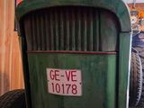 a green tractor with a sign on the front of it