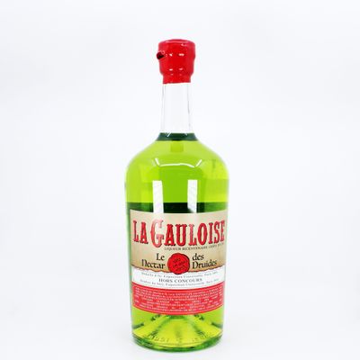 the bottle is full of a green liquid with a red cap