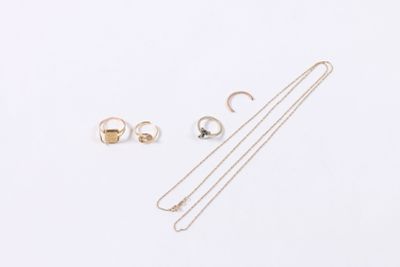 three pieces of jewelry are laying out on a white surface