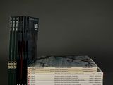 a stack of books sitting on top of each other on a table