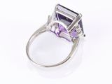 a close up of a ring with an amethorate and diamonds
