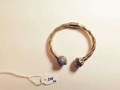 a close up of a bracelet and a tag on a table