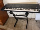 a keyboard that is sitting on a stand in a room