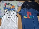 two t - shirts that are sitting in a box