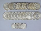 a close up of a bunch of silver coins on a table