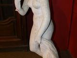 a statue of a man holding a cigarette in his hand