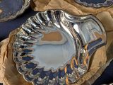 many different types of silver plates on a table
