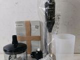 a blender that is sitting on a table next to a cup
