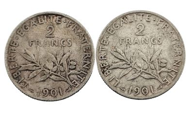 une pièce d'argent sur laquelle figure une branche d'olivier
