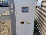 a white electrical box sitting outside of a building