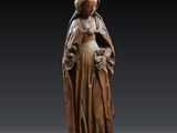 a wooden statue of a woman holding a child