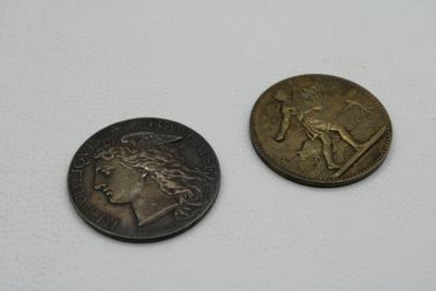 two coins that are sitting next to each other on a table