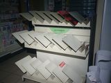 many boxes of pizza on the shelves in the store