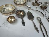 a lot of silver spoons and other silverware on a table