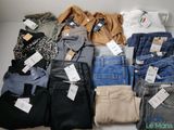 many different types of jeans on display on a table