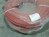 a large roll of red electrical wire wrapped in plastic