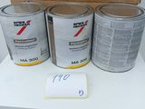 three cans of paint sitting on a table next to a cardboard box