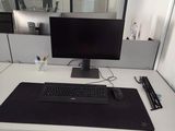 a computer desk with a keyboard and a monitor on it