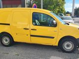 the yellow van is parked in front of a building in a parking lot