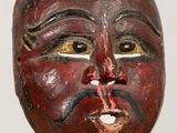 an image of a wooden mask on a stand