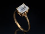 an image of a gold ring with a white diamond