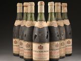 six bottles of wine are lined up in a row on a table