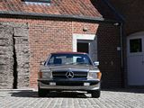 a silver car parked in front of a brick building