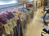 many clothes hanging on a rack in a store