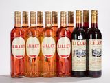 plusieurs bouteilles de vin sont alignées sur une surface blanche