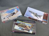 Trois maquettes d'avions de chasse sont posées sur une table