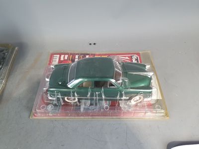 a green toy car sitting on top of a table