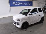 a small white car that is parked in a garage