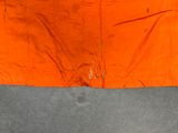 an orange piece of cloth with a hole in the middle of it