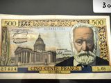 un vieux billet de banque sur lequel figure le portrait d'un homme barbu