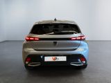 the rear end of a silver car in a white room
