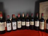 several bottles of red wine are lined up on a table