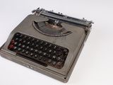 an old typewriter sitting on a table with a white background