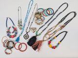 a lot of different necklaces and bracelets on the table
