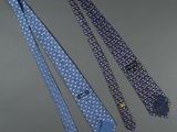 three ties are laying next to each other on a table