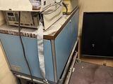 a pile of boxes on top of a cart in a room