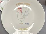a white plate with a drawing of a rooster on it